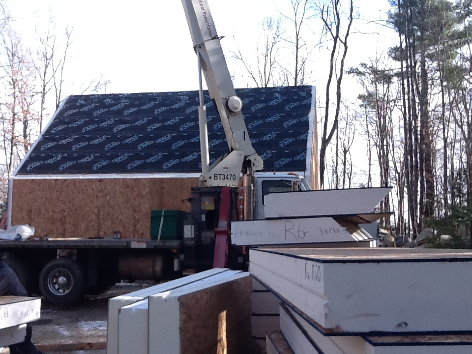 Installing roof SIPs over a timber frame with a crane