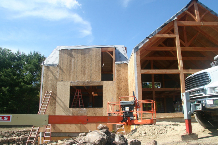 Manlift being used to install SIPs on a timber frame structure